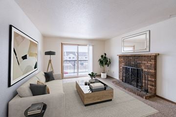 Fargo apartment for rent - a living room with a fireplace and a couch and a table