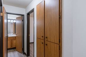 Fargo apartment for rent - the entrance to a bathroom with two closets and a mirror. Fargo, ND Prairiewood Courts Apartments