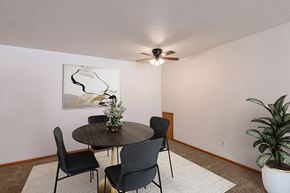 Fargo apartment for rent - a dining room with a table and chairs and a ceiling fan. Fargo, ND Schrock Apartments