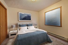 Fargo apartment for rent - a bedroom with a large bed and a large window. Fargo, ND Somerset Apartments