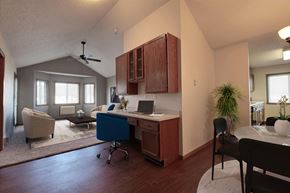 Fargo apartment for rent - a desk with a laptop computer in a room with a couch and a table. Fargo, ND Somerset Apartments