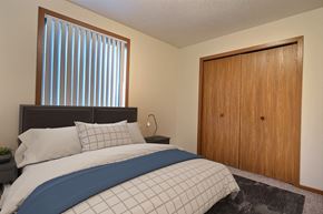 Fargo apartment for rent - a bedroom with a bed and a closet. Fargo, ND Southgate Apartments