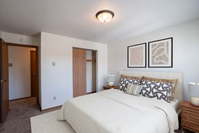 Fargo apartment for rent - a bedroom with a large bed and a closet. Fargo, ND Southview Village Apartments