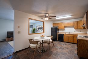 Fargo apartment for rent - a kitchen and dining area with a white table and chairs. Fargo, ND Southview Village Apartments