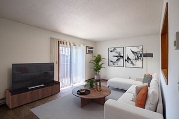 Fargo apartment for rent - a living room with white furniture and a television