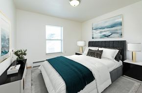 Fargo apartment for rent - a bedroom with a large bed and a window. Fargo, ND Sunrise North