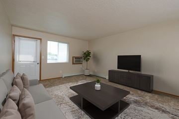 Fargo apartment for rent - a living room with a couch and a coffee table and a tv