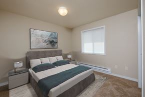 Fargo apartment for rent - Fargo, ND Thunder Creek Apartments. A bedroom with a bed, window, and two nightstands
