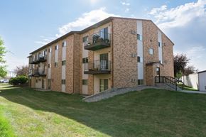Fargo apartment for rent - a brick apartment building with balconies. Fargo, ND Village West Apartments