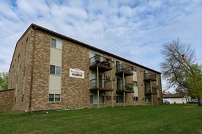 Fargo apartment for rent - the exterior of a brick apartment building with balconies. Fargo, ND West Oak Apartments.
