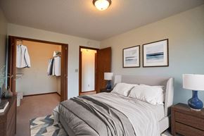 Fargo apartment for rent - a bedroom with a bed and two night stands. Fargo, ND Westwood Estates Apartments