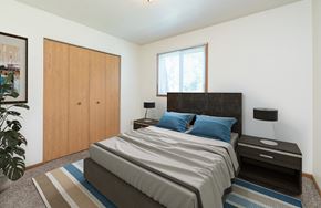 Fargo apartment for rent - a bedroom with a bed and a closet and a window. Fargo, ND White Ridge Apartments