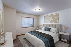 Fargo apartment for rent - a bedroom with a bed and a window. Fargo, ND Willow Park Apartments