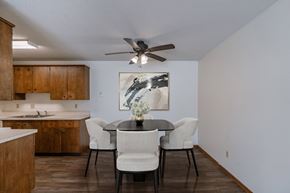 Fargo apartment for rent - a dining room with a table and chairs and a ceiling fan. Fargo, ND Windsor Apartments