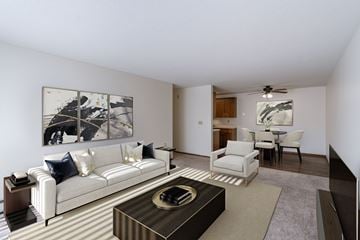 Fargo apartment for rent - a living room with a couch and a coffee table and a dining room