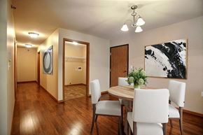 Fargo apartment for rent - a dining room with a wooden table and white chairs. Fargo, ND Wolf Creek Apartments