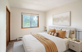 Fargo apartment for rent - a bedroom with a large bed and a window. Fargo, ND Brookfield Apartments