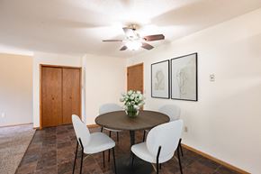 Fargo apartment for rent - a dining room with a table and chairs and a ceiling fan.Fargo, ND Brookfield Apartments