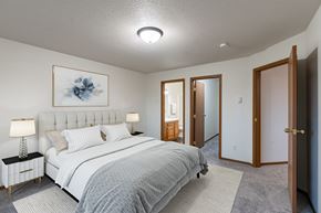 Fargo apartment for rent - a bedroom with a bed and a closet. Fargo, ND Brownstone Apartments