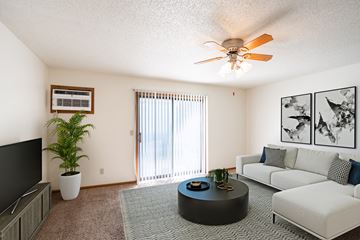 Fargo apartment for rent - a living room with a couch and a coffee table and a ceiling fan
