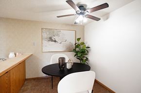 Fargo apartment for rent - a dining room with a table and chairs and a ceiling fan . Fargo, ND Cedar Pointe Apartments