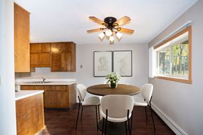 Fargo apartment for rent - a kitchen with a table and chairs and a ceiling fan. Fargo, ND Country Club Apartments