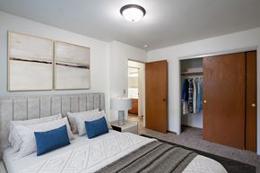 Fargo apartment for rent - a bedroom with a bed and a closet.Fargo, ND Crown Court 1 Apartments