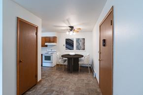 Fargo apartment for rent - a kitchen and dining room with a small table and a ceiling fan. Fargo, ND Crown Court 1 Apartments