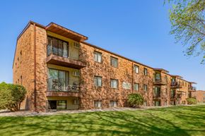 Fargo apartment for rent - a brick apartment building with green grass and a blue sky