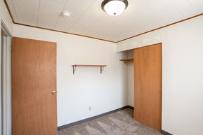 Fargo apartment for rent - an empty room with a door to a closet. Fargo, ND Forest Avenue Apartments