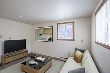 Fargo apartment for rent - a living room with a couch and a coffee table and a television