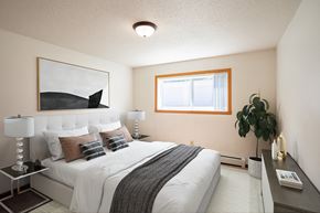 Fargo apartment for rent - a bedroom with a large bed and a window. Fargo, ND Hawn Apartments