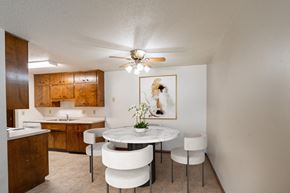 Fargo apartment for rent - a kitchen and dining room with a table and chairs and a ceiling fan. Fargo, ND Hawn Apartments