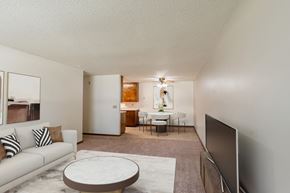 Fargo apartment for rent - a living room with a couch and a coffee table and a dining room and kitchen. Fargo, ND Hawn Apartments