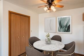 Fargo apartment for rent - a dining room with a marble table and chairs and a ceiling fan. Fargo, ND Hunters Run 2 Apartments