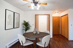 Fargo apartment for rent - a dining room with a table and chairs and a ceiling fan. Fargo, ND Kentwood Manor Apartments