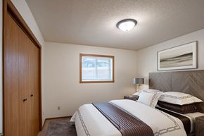 Fargo apartment for rent - a bedroom with a bed and a closet. Fargo, ND Monticello Apartments