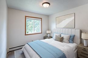 Fargo apartment for rent - a bedroom with a bed and a window. Fargo ND Morningside Apartments