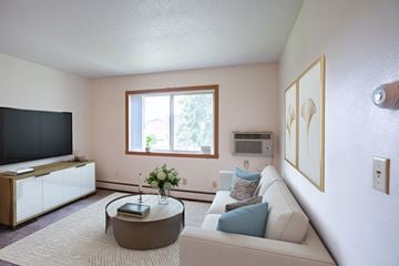 Fargo apartment for rent - a living room with a couch and a coffee table and a television