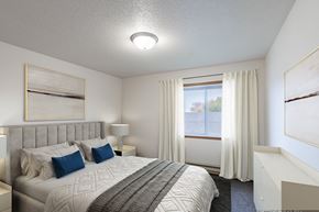 Fargo apartment for rent - a bedroom with a large bed and a window. Fargo, ND Oxford Apartments