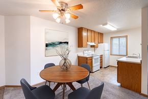Fargo apartment for rent - a dining room with a table and chairs and a kitchen. Fargo, ND Oxford Apartments