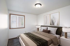 Fargo apartment for rent - a bedroom with a large bed and a window. Fargo, ND Pacific Park 2 Apartments