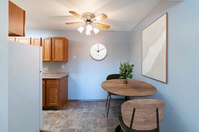 Fargo apartment for rent - a dining room with a table and a clock on the wall. Fargo, ND Pacific Park Apartments