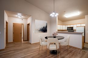 West Fargo apartment for rent - a dining room with a table and chairs and a kitchen. Fargo, ND West Lake Apartments