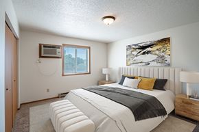 Fargo apartment for rent - the master bedroom has a king sized bed and a large window