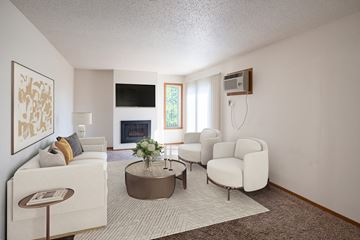 Fargo apartment for rent - a living room with white furniture and a fireplace
