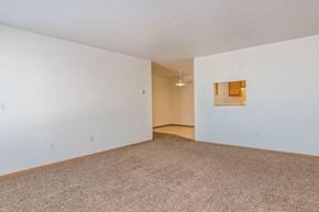 Fargo townhouse for rent - an empty living room with white walls and carpet. Fargo, ND Foxtail Townhomes