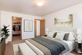 Fargo townhouse for rent - a bedroom with a bed and a closet. Fargo, ND Foxtail Creek Townhomes
