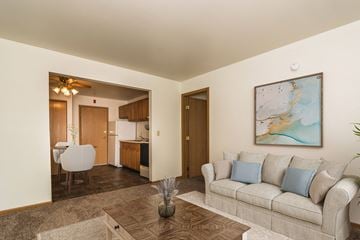 Grand Forks apartment for rent - Grand Forks, ND Amberwood Apartment a living room with a couch and coffee table with a dining room in the background