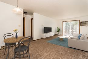 Grand Forks townhouse for rent - Grand Forks, ND Autumn Apartments a living room with a table and chairs and a television on the wall